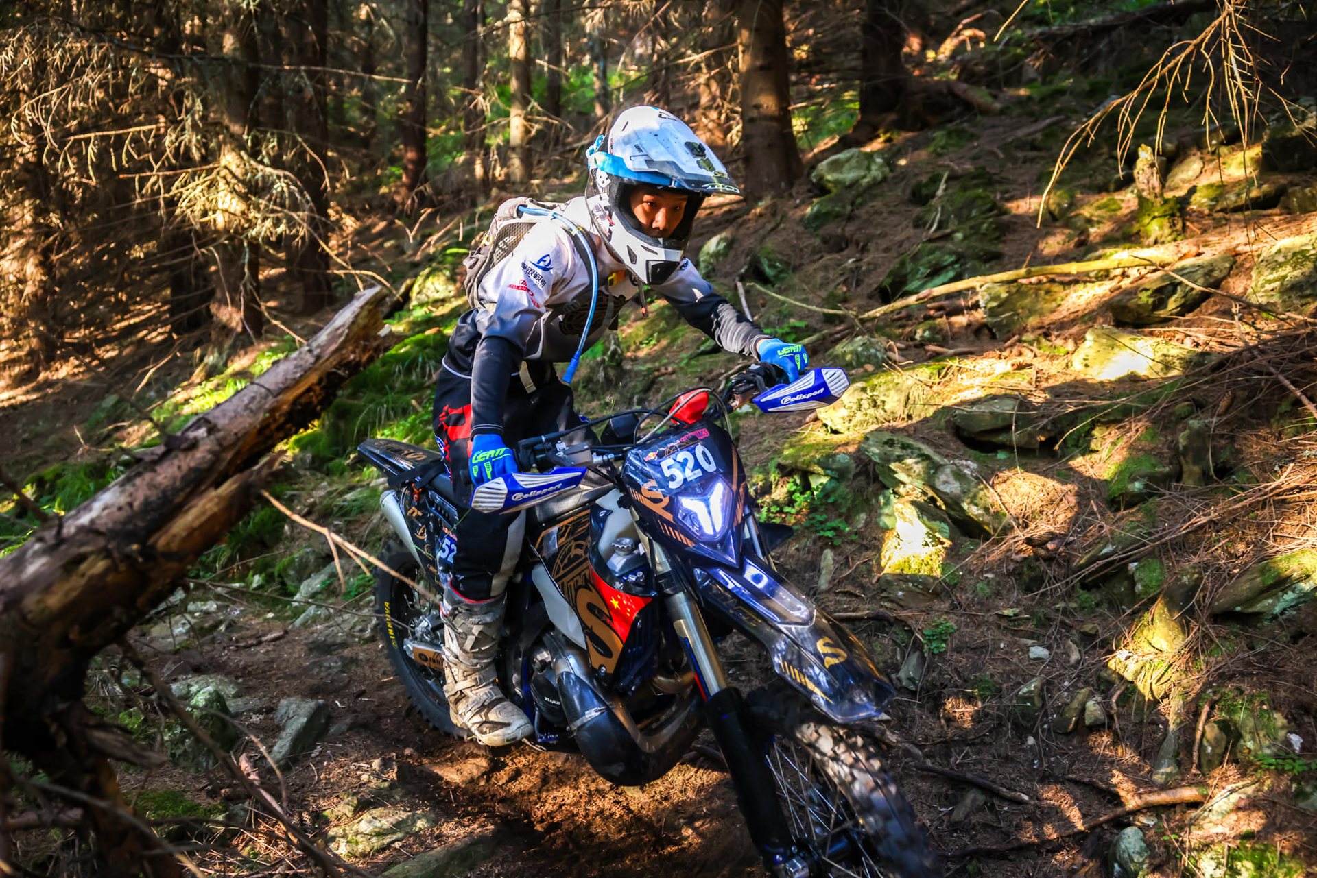 Yang Songyi riding a production-based TAIMU S300R through a forest section in Romania